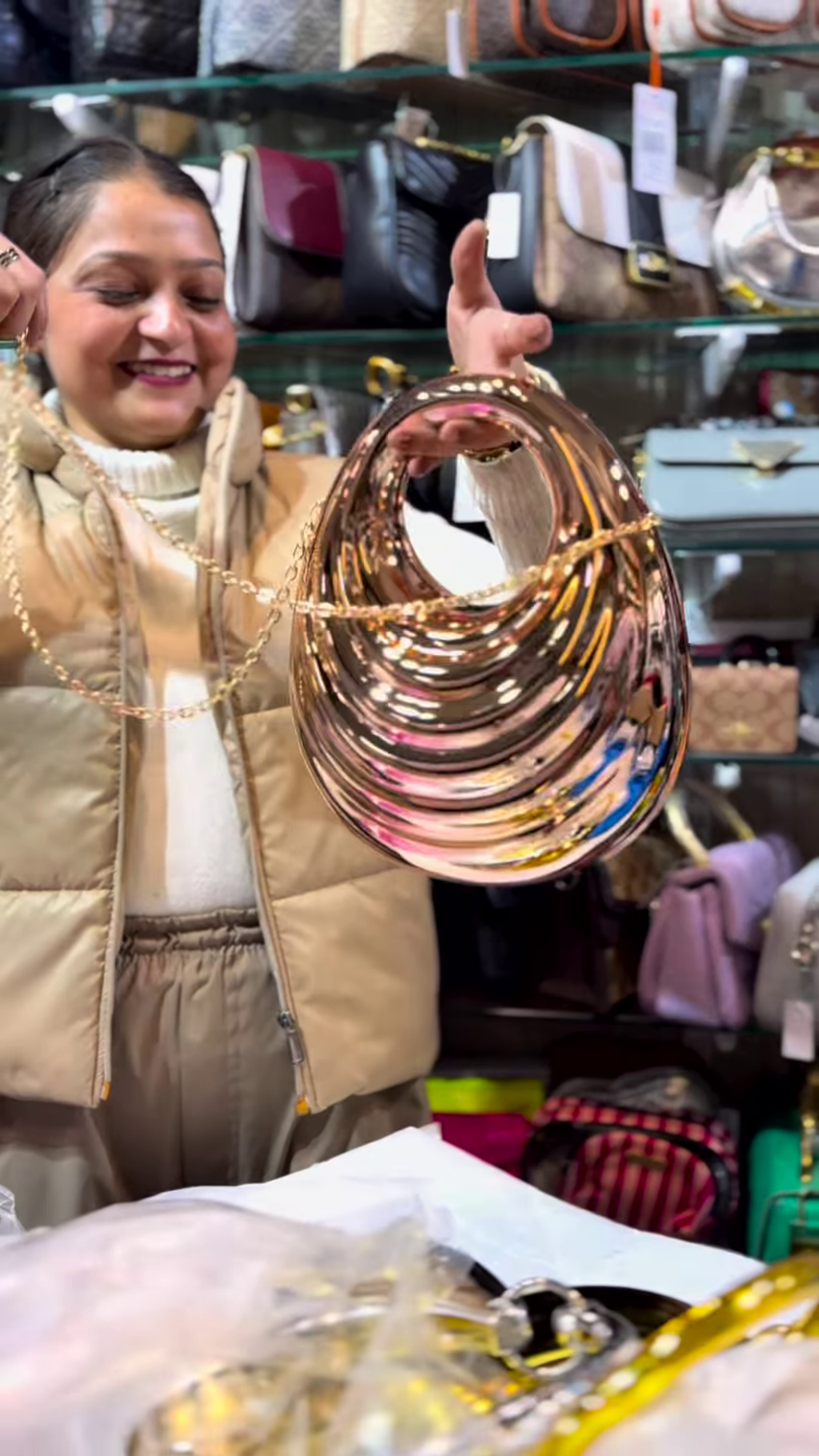 Sculptural Rose Gold-Toned Metallic Clutch with Wavy Design and Chain Strap